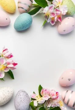 Easter eggs and spring flowers creating border background Stock Photos