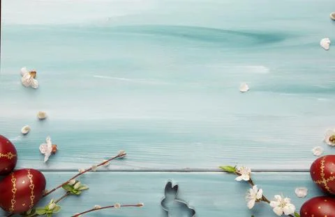 Easter eggs and spring white flowers and willow branches on Easter blue wood  Stock Photos