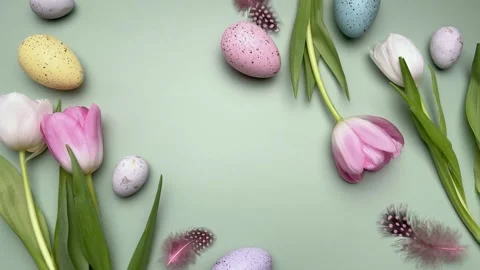 Easter eggs and tulips gently rotating on pastel green background Stock Footage 305307178