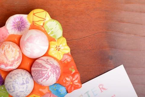 Easter eggs and white paper on a wooden background Stock Photos