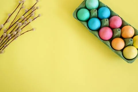 Easter eggs and willow branches on a yellow background Stock Photos
