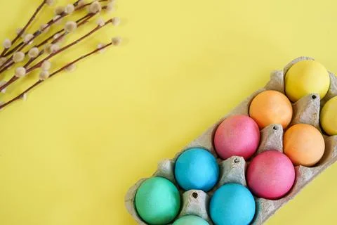 Easter eggs and willow branches on a yellow background Stock Photos