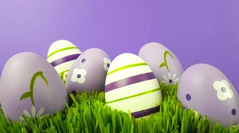 Easter eggs are multicolored on the green natural grass. background backgroun Stock Photos