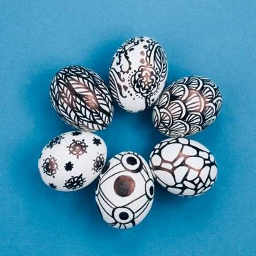 Easter eggs are painted black and white, abstraction, laid out in a circle. Stock Photos