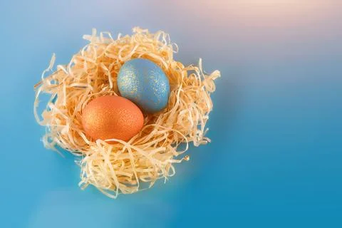 Easter eggs are painted blue with gold and orange gold. Stock Photos