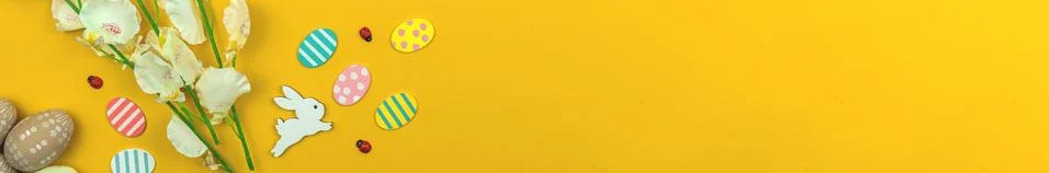 Easter eggs banner background with easter bunny and spring flowers, yellow ba Stock Photos