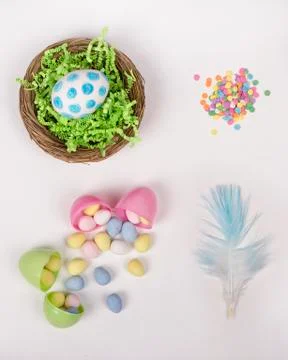 Easter eggs, basket, and candy on a white background Stock Photos