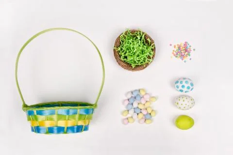 Easter eggs, basket, and candy on a white background Stock Photos