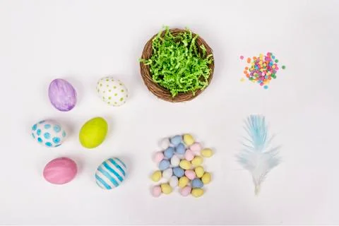 Easter eggs, basket, and candy on a white background Stock Photos