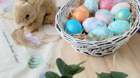 Easter eggs in a basket and toy rabbit. Easter composition. Holiday concept. Stock Footage 269496810