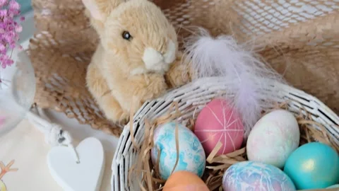 Easter eggs in a basket and toy rabbit. Easter composition. Holiday concept. Stock Footage 270718523