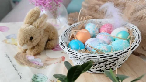 Easter eggs in a basket and toy rabbit. Easter composition. Holiday concept. Stock Footage 270723016