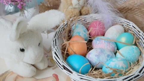 Easter eggs in a basket and toy rabbit. Easter composition. Holiday concept. Stock Footage 270723089