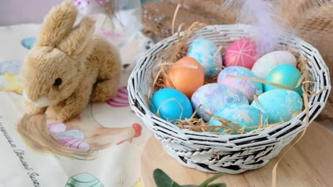 Easter eggs in a basket and toy rabbit. Easter composition. Holiday concept. Stock Footage 271531833