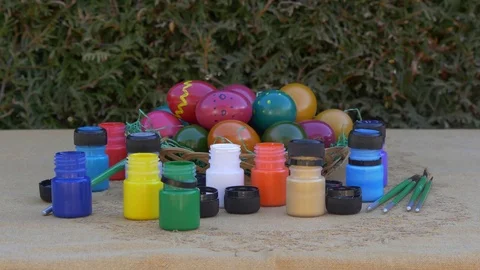 Easter eggs in a basket and tubes with paint Stock Footage 73457803