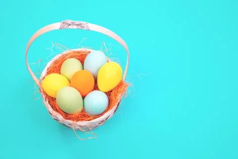 Easter eggs basket on blue background Stock Photos