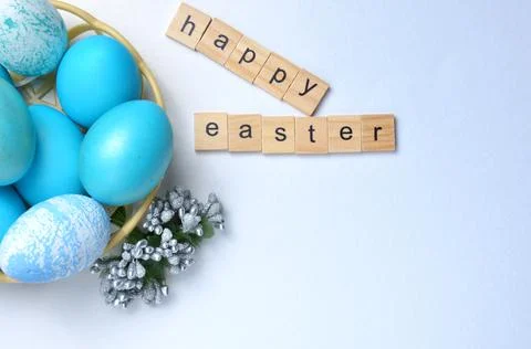 Easter eggs in a basket close-up on a gray background. Happy Easter. Stock Photos