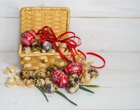 Easter eggs in a basket decorated with a red bow . Eve of Easter. Stock Photos