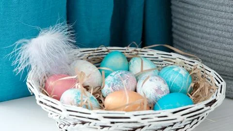 Easter eggs in a basket. Easter composition. Holiday concept. Stock Photos