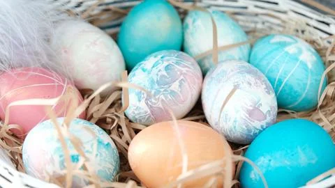 Easter eggs in a basket. Easter composition. Holiday concept. Stock Photos