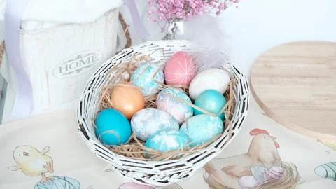 Easter eggs in a basket. Easter composition. Holiday concept. Stock Photos