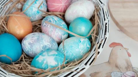 Easter eggs in a basket. Easter composition. Holiday concept. Stock Photos