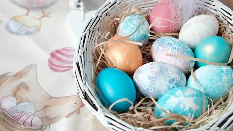 Easter eggs in a basket. Easter composition. Holiday concept. Stock Photos