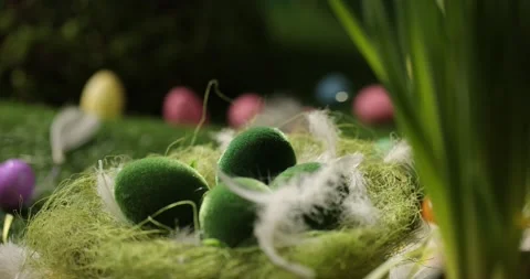 Easter eggs in basket, feathers falling down. Easter eggs and feathers in a Stock Footage 175439062