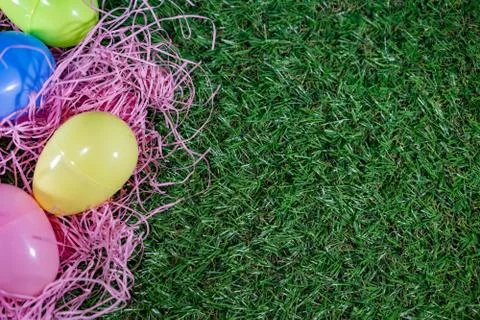 Easter eggs on a basket with grass and green background for happy easter cele Stock Photos
