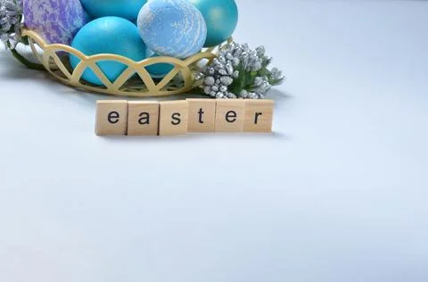 Easter eggs in a basket on a gray background. Stock Photos