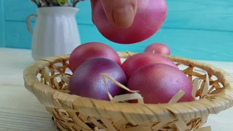 Easter eggs in a basket hand holding a slow shot Stock Footage 90308914