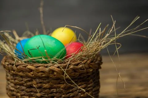 Easter eggs in a basket with hay Stock Photos