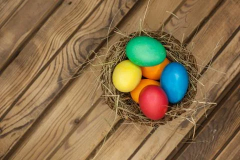 Easter eggs in a basket with hay Stock Photos
