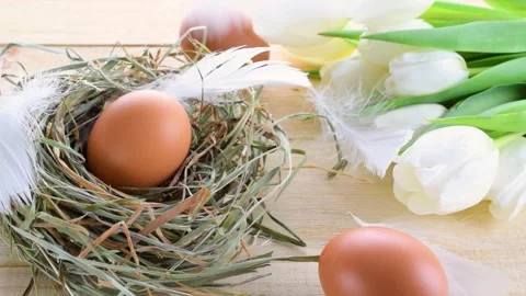 Easter eggs basket. Natural colour egg in basket with spring tulips, white Stock Footage 148576801