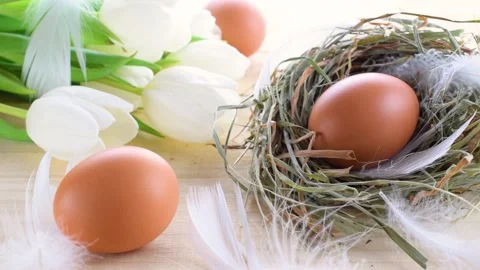 Easter eggs basket. Natural colour egg in basket with spring tulips, white Stock Footage 149620148