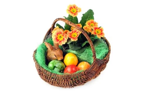 Easter eggs in basket with primula and easter bunny Stock Photos