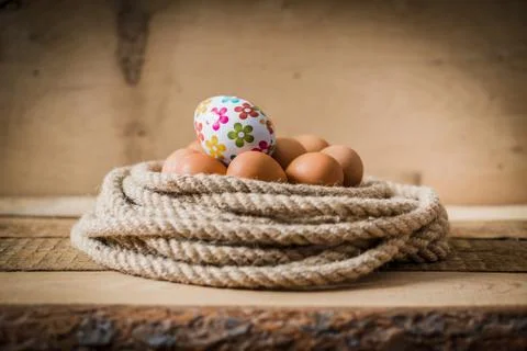 Easter eggs in a basket with a rope Stock Photos