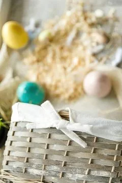 Easter eggs in a basket with spring flowers and grass Stock Photos