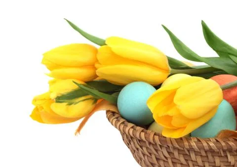 Easter eggs in basket with tulips Foto stock