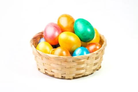 Easter eggs in a basket on a white background. Stock Photos