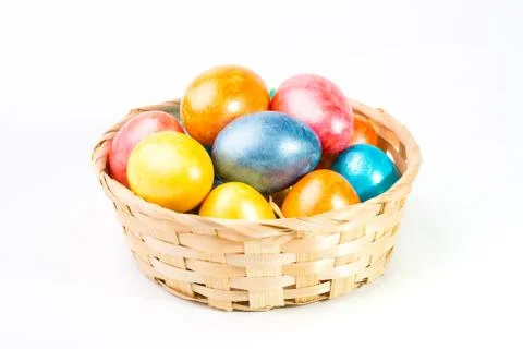 Easter eggs in a basket on a white background. Stock Photos