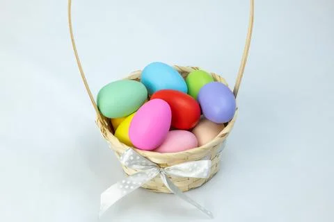 Easter eggs in a basket on a white background, horizontal high-angle view Stock Photos