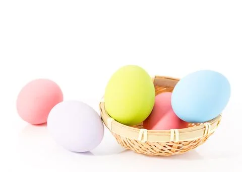 Easter eggs in basket on white Stock Photos