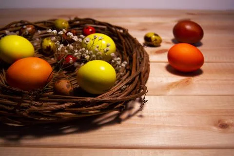 Easter eggs in a basket on wodden table Stock Photos