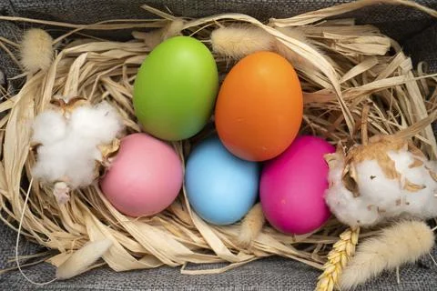 Easter Eggs in basket on yellow background Stock Photos