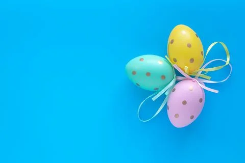Easter eggs on a blue background, gift card with copy space, festive mockup. Stock Photos