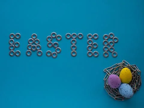 Easter eggs on blue background with metal chain Stock Photos