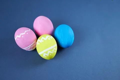 Easter eggs on blue background with space for text. Stock Photos
