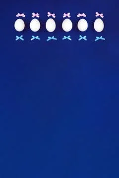 Easter eggs with bows on a blue background. Photos