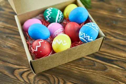 Easter eggs in a box on a wooden background, close-up Stock Photos